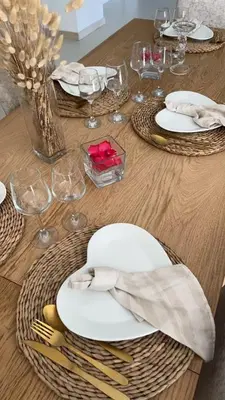a wooden table with white plates and wine glasses at LE MAS MILA in Monteux