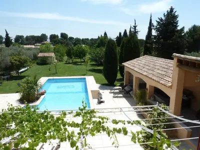 a villa with a swimming pool in a garden at Magnifique villa au calme avec piscine, sauna et jacuzzi in Pélissanne