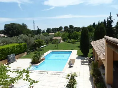 a view of a swimming pool in a yard at Magnifique villa au calme avec piscine, sauna et jacuzzi in Pélissanne