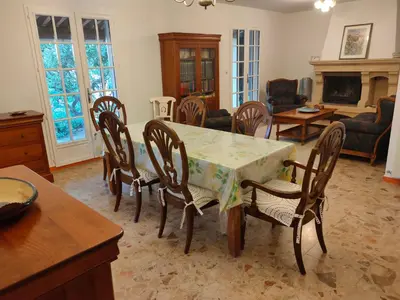 a dining room with a table and chairs and a living room at Roussillon in Roussillon