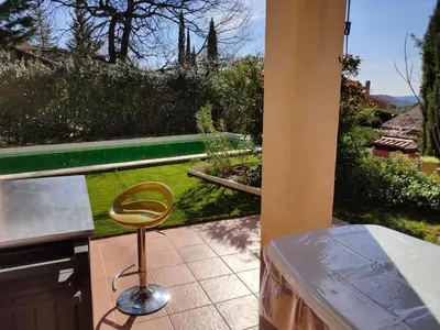 a stool sitting on a patio with a view of a garden at Roussillon in Roussillon