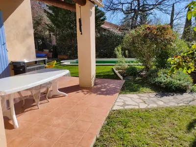 a patio with a white bench in a yard at Roussillon in Roussillon