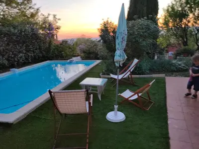 a pool with a table and chairs and an umbrella at Roussillon in Roussillon