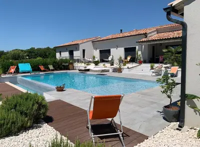 a swimming pool with a chair in a yard at Charmant Appartement au calme avec piscine au pied du Ventoux en Provence in Carpentras