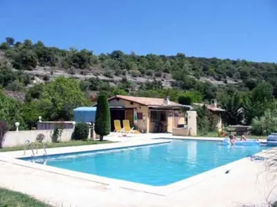 a large swimming pool in front of a house at Mas de Peyre in Le Beaucet