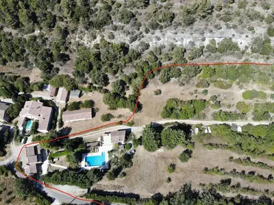 an aerial view of a house with a red road at Mas de Peyre in Le Beaucet