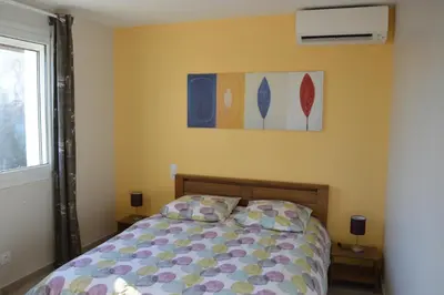 a bedroom with a bed and a painting on the wall at Le Cavaou in Mérindol