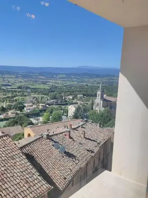 an aerial view of a city with roofs at BOHO 2 Vue Panoramique in Bonnieux