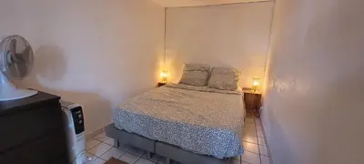 a small bedroom with a bed with two pillows at Appartement duplex sur les toits d'Aix avec terrasse ensoleillée in Aix-en-Provence