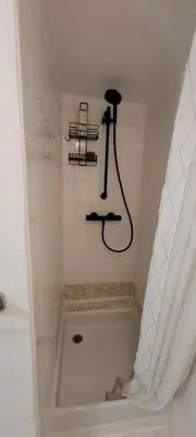 a bathroom with a bath tub with a shower at Appartement duplex sur les toits d'Aix avec terrasse ensoleillée in Aix-en-Provence