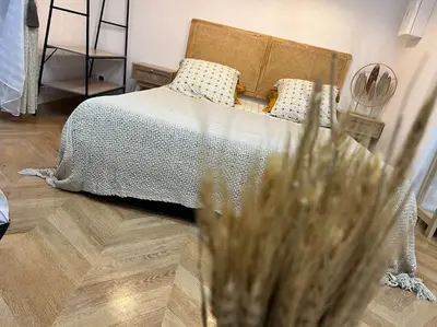 a bedroom with a bed and a wooden floor at 4M Studio in Jouques