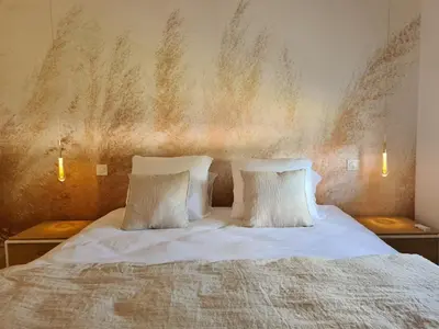 a bedroom with a white bed with two pillows at Villa de luxe en Provence Piscine Chauffée in Puget