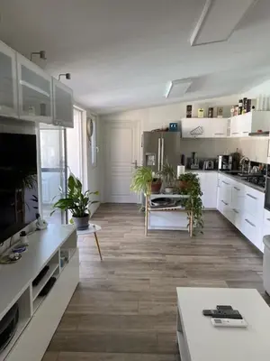 a large kitchen with white cabinets and potted plants at Petit paradis en Provence in Velleron