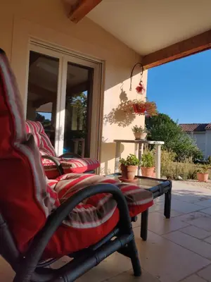a group of chairs sitting on a porch at LE CHARME DU VENTOUX in Crillon-le-Brave