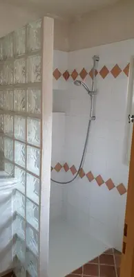 a shower in a bathroom with a glass door at Les Oliviers De Notre Dame in Mazan