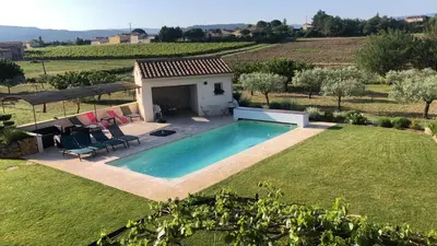 a swimming pool in the yard of a house at Les Oliviers De Notre Dame in Mazan