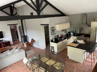 a kitchen and living room with a couch and a table at Ar de Vie villa chaleureuse en Provence in Ventabren