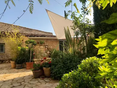 a garden in front of a house with plants at L’île aux fleurs in Ventabren