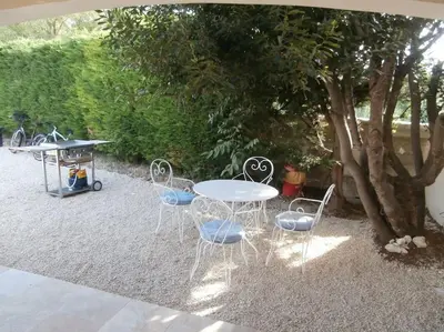 a table and chairs sitting under a tree at gîte à Caromb ( Mt Ventoux ) in Caromb