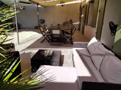 a living room with a couch and a table at MAS LAURIE in Cheval-Blanc