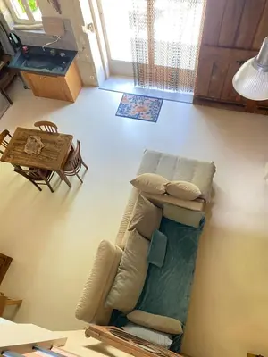 a living room with a couch and a table at Cécile - Mas de Rousseau in Eyragues