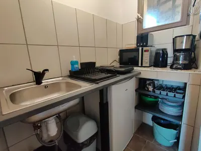 a small kitchen with a sink and a microwave at STUDIO DU CHARME PROVENCAL in Sénas