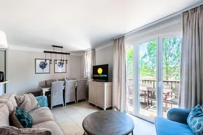 a living room with a couch and a dining room at Les Coteaux de Pont Royal en Provence - maeva Home - Maison chaleureuse climatisée 4 pièces 6 personnes - Prestige - super Home MAE-2304 in Mallemort