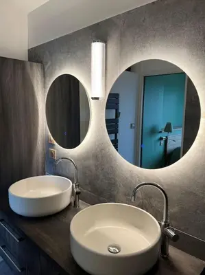 a bathroom with a white sink and two mirrors at Villa de charme in Châteauneuf-de-Gadagne