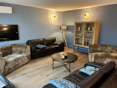 a living room with two couches and a table at Villa de charme in Châteauneuf-de-Gadagne