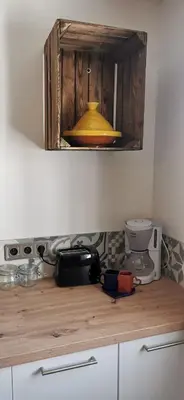 a kitchen counter top with a yellow light above it at La Petite Reine Du Ventoux in Sault-de-Vaucluse