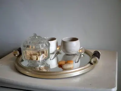 a table with a tray with dishes and a glass container at La maison de Muriel in Rustrel