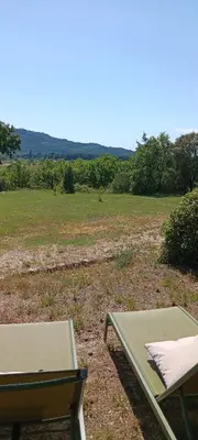 a picnic table and a bench in a field at La Pifote in Villes-sur-Auzon