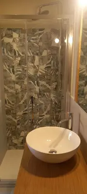 a white sink in a bathroom with a wall at La Pifote in Villes-sur-Auzon