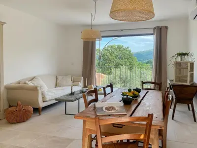 a living room with a table and a couch at La Mirande à Lacoste in Lacoste
