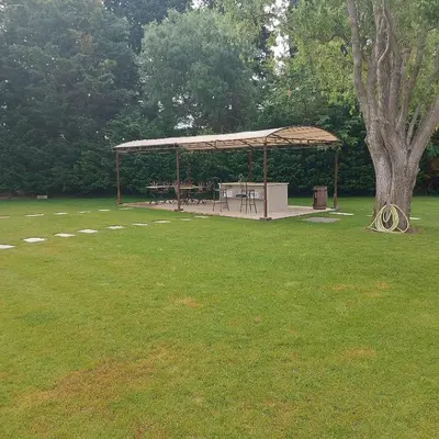 a picnic shelter in a park with a tree at Mas Sourso in Eygalières
