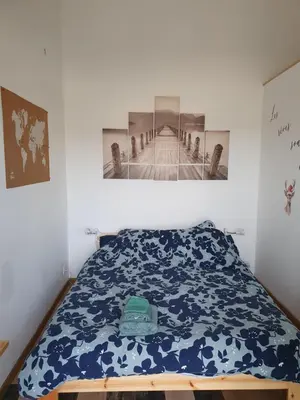 a bedroom with a bed with a blue comforter at Pura vida in Mazan