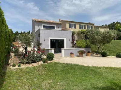 a large house with a yard with a driveway at Maison avec ses 2 terrasses et sa piscine in Eyragues