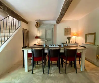 a dining room with a table and chairs at La Bastide des Chênes Lacoste in Lacoste