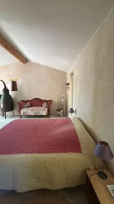 a bedroom with a large bed in a room at La Bastide des Chênes Lacoste in Lacoste
