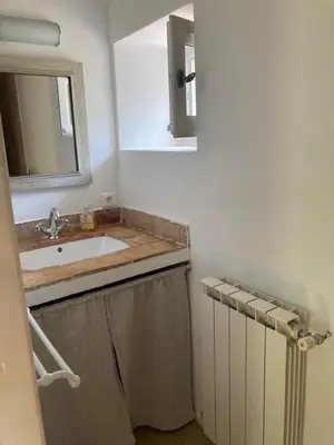 a bathroom with a sink and a mirror at La Bastide des Chênes Lacoste in Lacoste