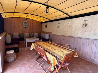 a room with a table and chairs and a couch at Beau Ciel in Châteauneuf-de-Gadagne