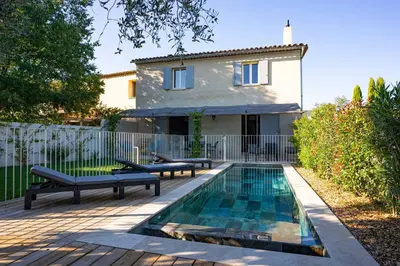 a house with a swimming pool in front of a house at Villa Cocoon Lourmarin in Lourmarin