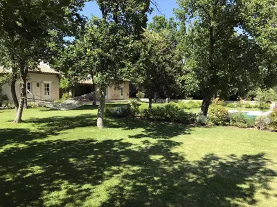 a yard with trees and a house at La Bergerie Provencale - Luberon - Provence - villa with heated pool in Roussillon