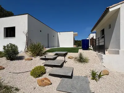 a courtyard with benches and a building at Noyau & Pepin in Rognes