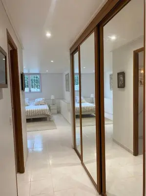a room with two beds and a room with mirrors at T2 avec jardin et piscine privée in Velaux