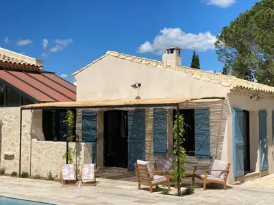 a house with a patio and a swimming pool at Mas de charme avec piscine au coeur des Alpilles in Eygalières