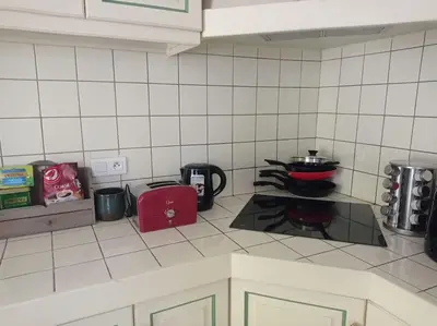 a kitchen with a stove with a pot on it at maison piscine privée Robion Luberon idéal famille in Robion en Luberon