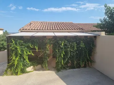 a pergola covered in ivy on a house at Ma Charmante Maison En Provence in Lançon-Provence