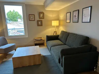 a living room with a couch and a coffee table at CABADOL - Appartement Aix centre historique - très calme - 50m cours Mirabeau in Aix-en-Provence