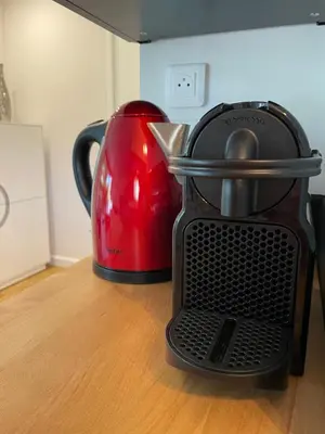 a red and black toaster sitting on a table at L’Écrin in Aix-en-Provence